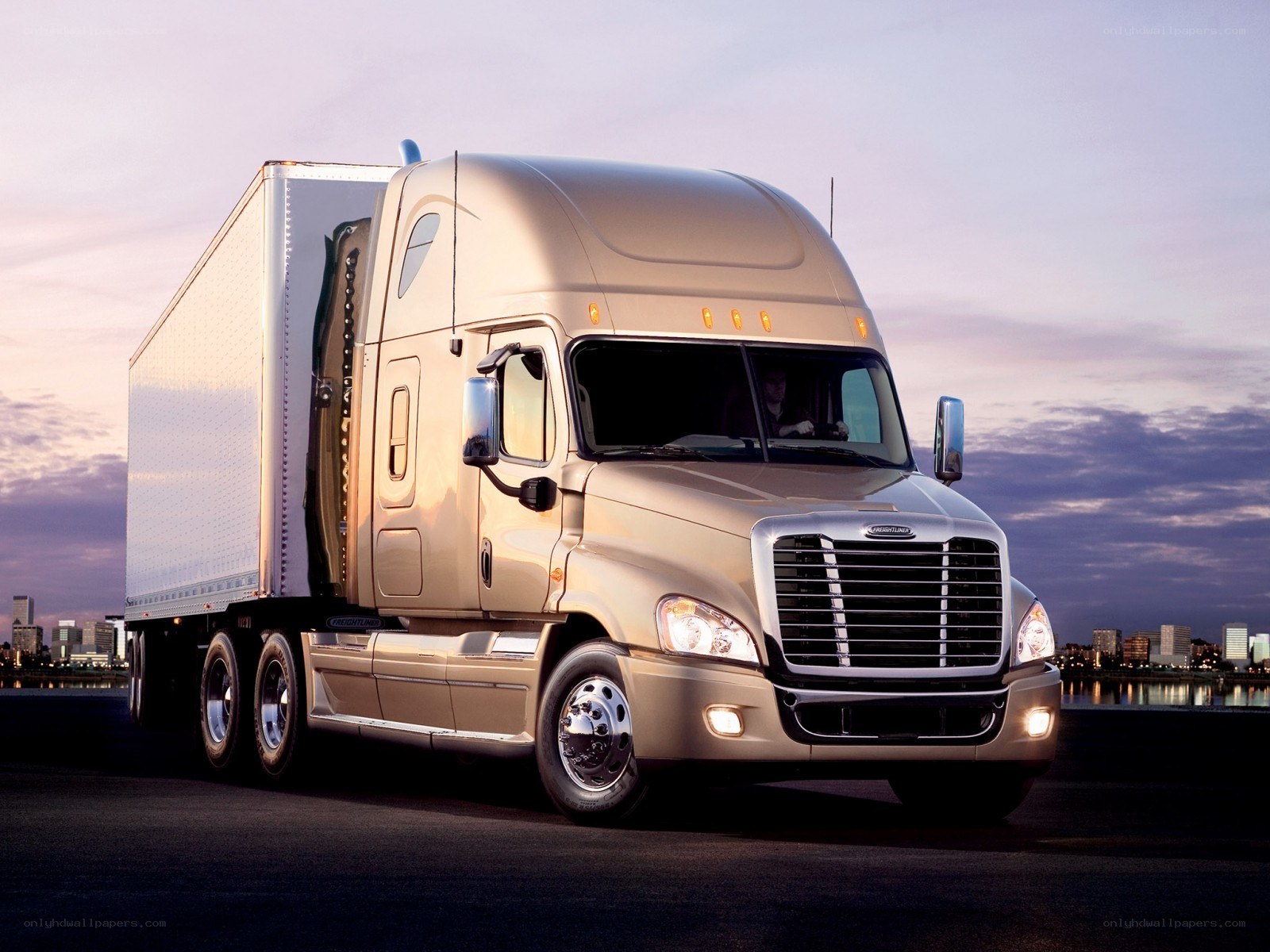 Gold Freightliner truck at dusk