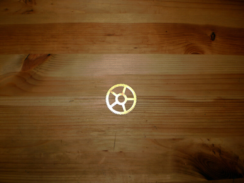 Gold Gear on Wood