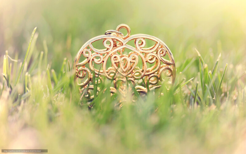 Gold heart pendant in grass