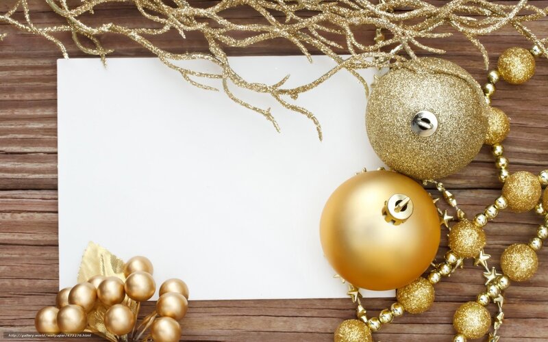 gold holiday ornaments on wood