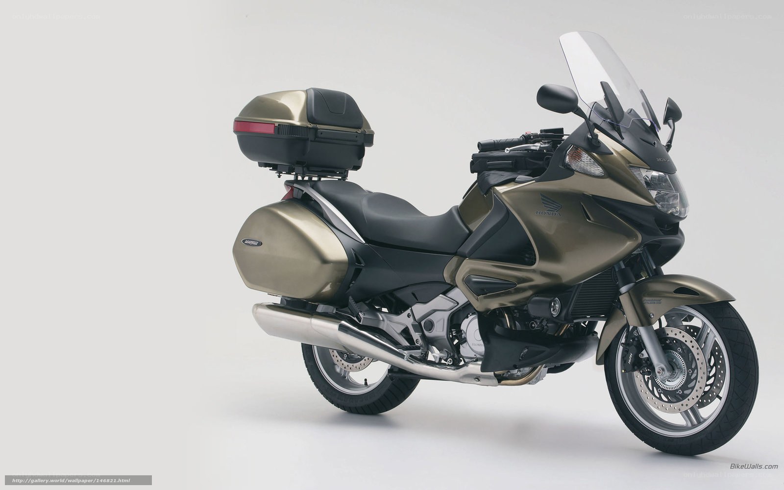 Gold Honda motorcycle with luggage