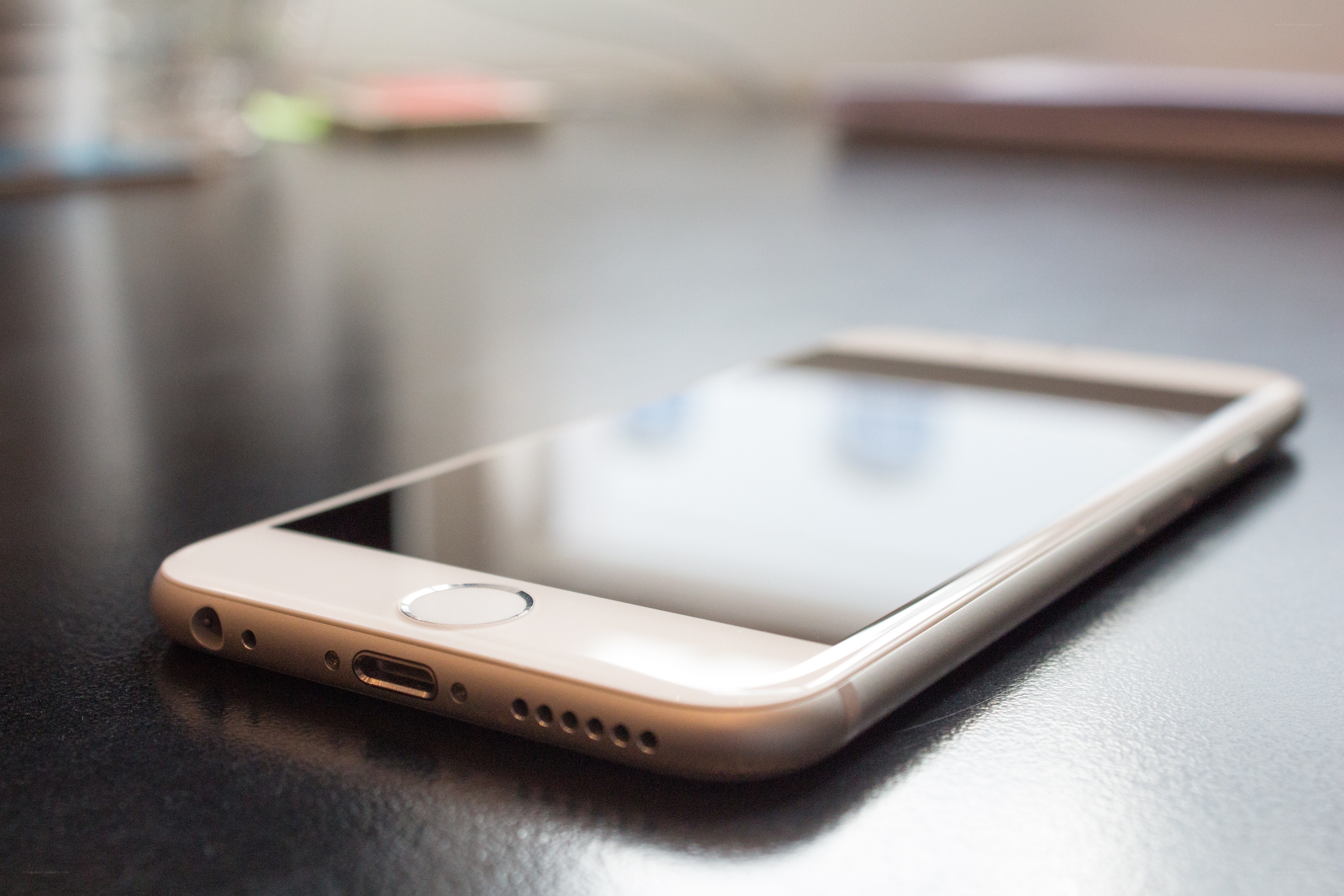 gold iPhone on dark surface