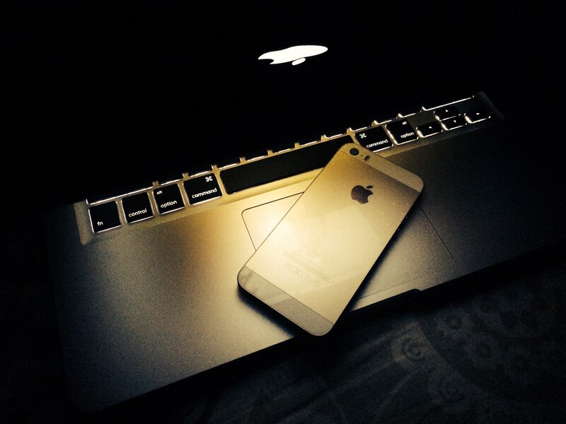Gold IPhone on Laptop