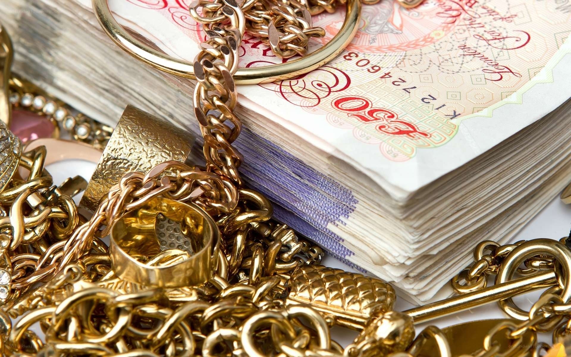 gold jewelry and money stack