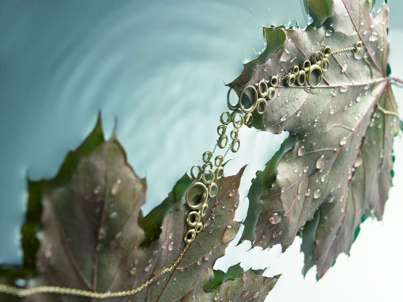 gold jewelry on wet leaves