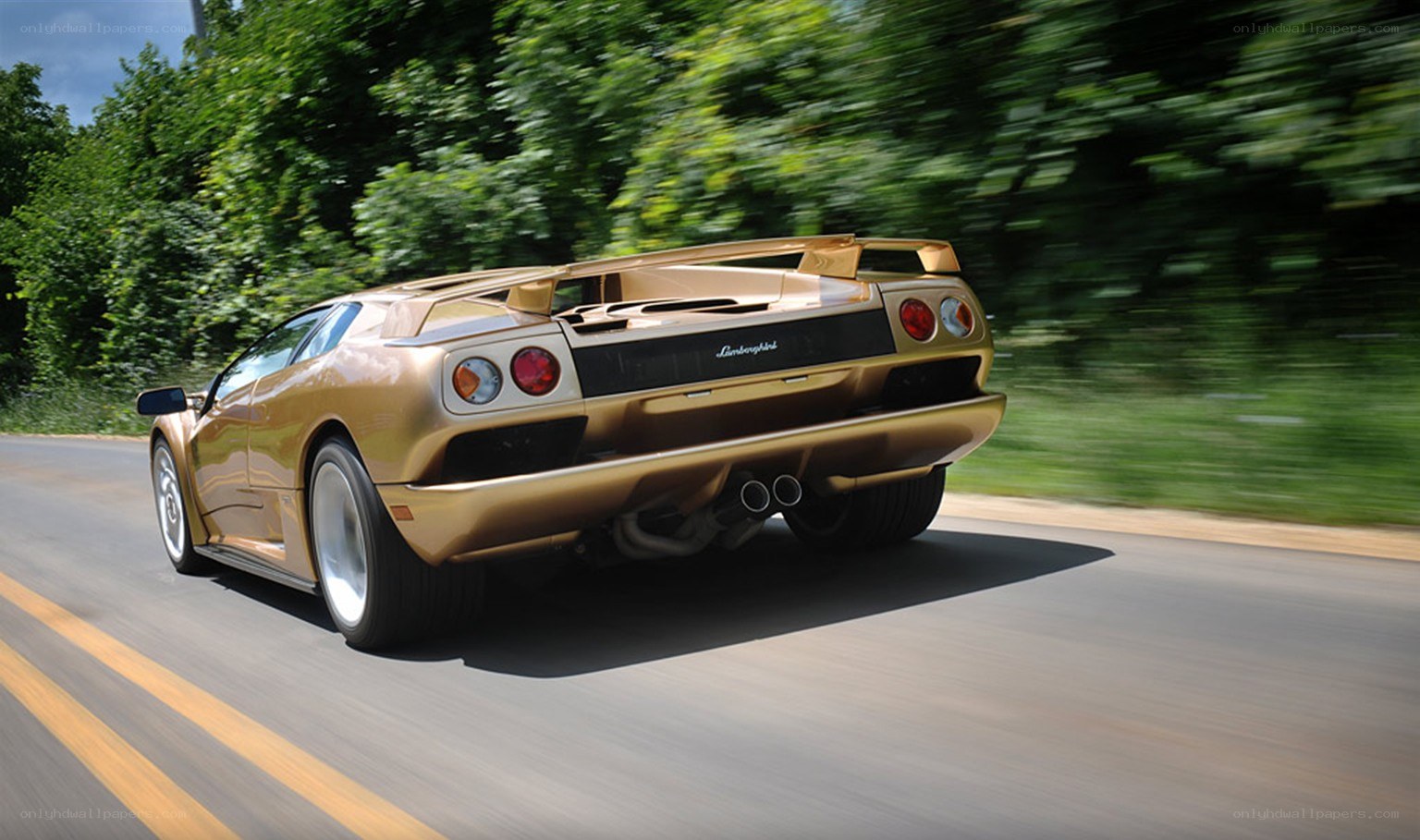 gold lamborghini driving on road