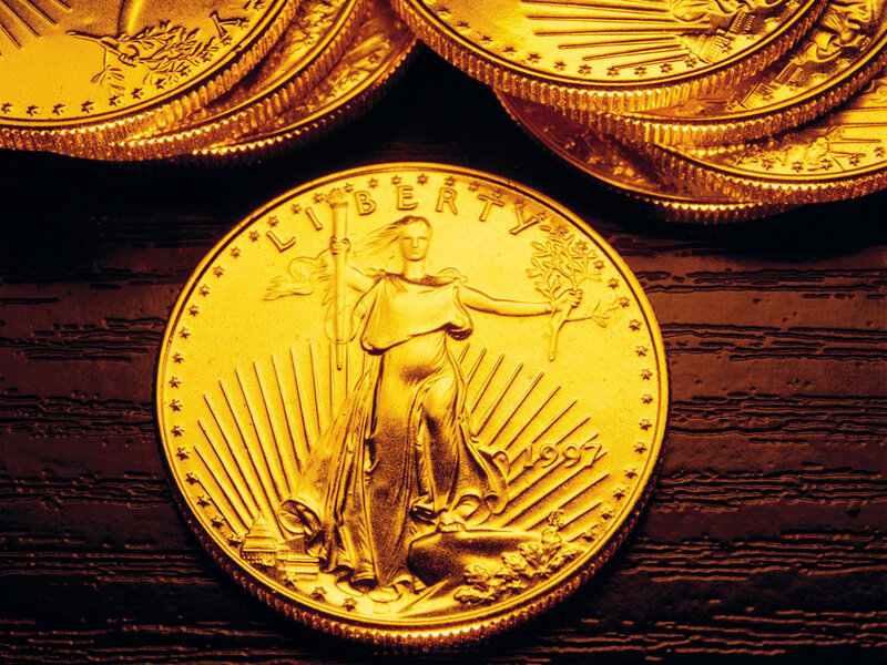 Gold Liberty coin on wood