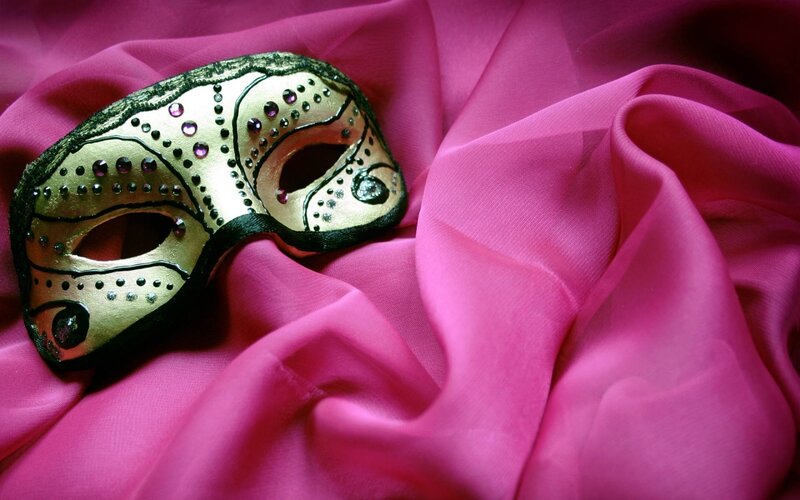 gold mask on pink fabric