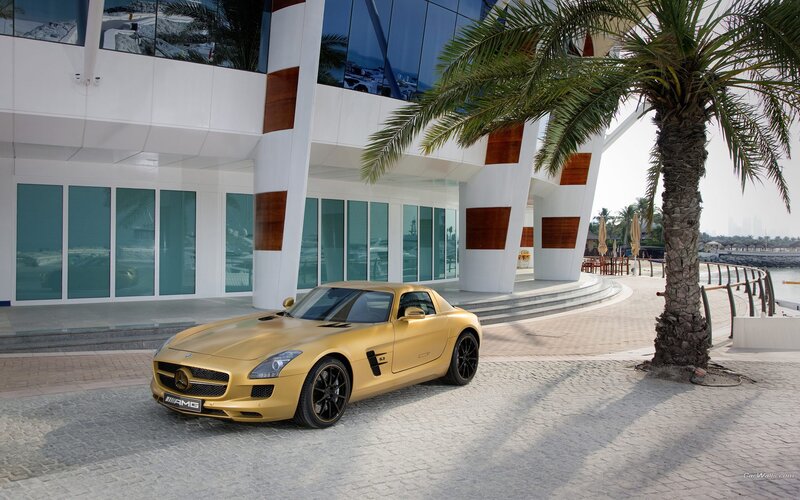 Gold Mercedes-AMG SLS parked outside