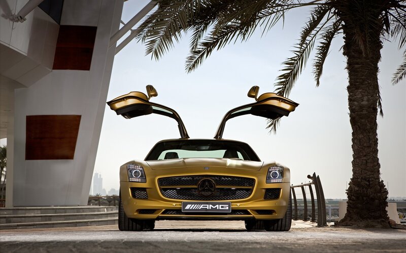 Gold Mercedes-AMG SLS with doors open