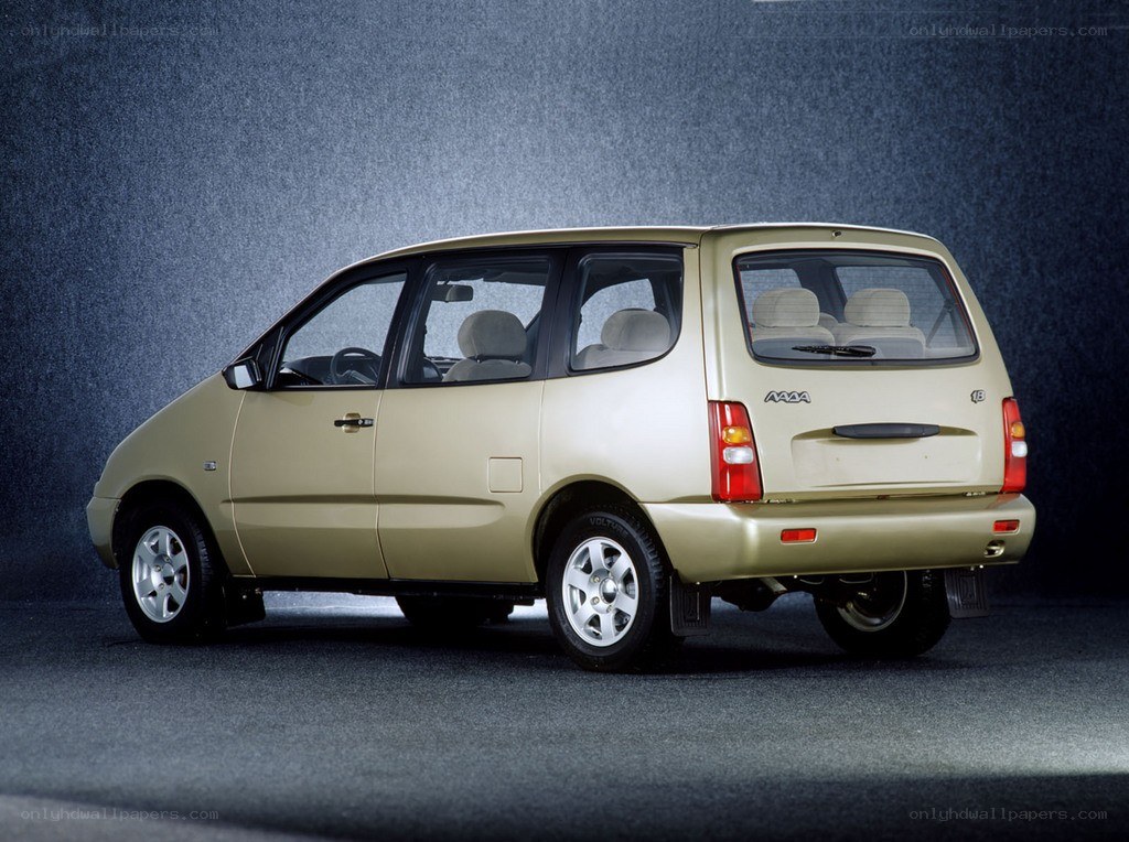 gold minivan from side rear