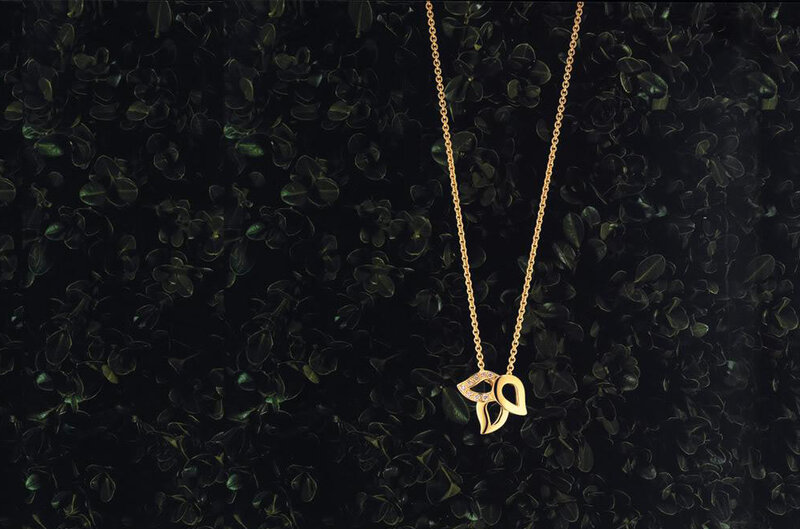 gold necklace with leaf pendant