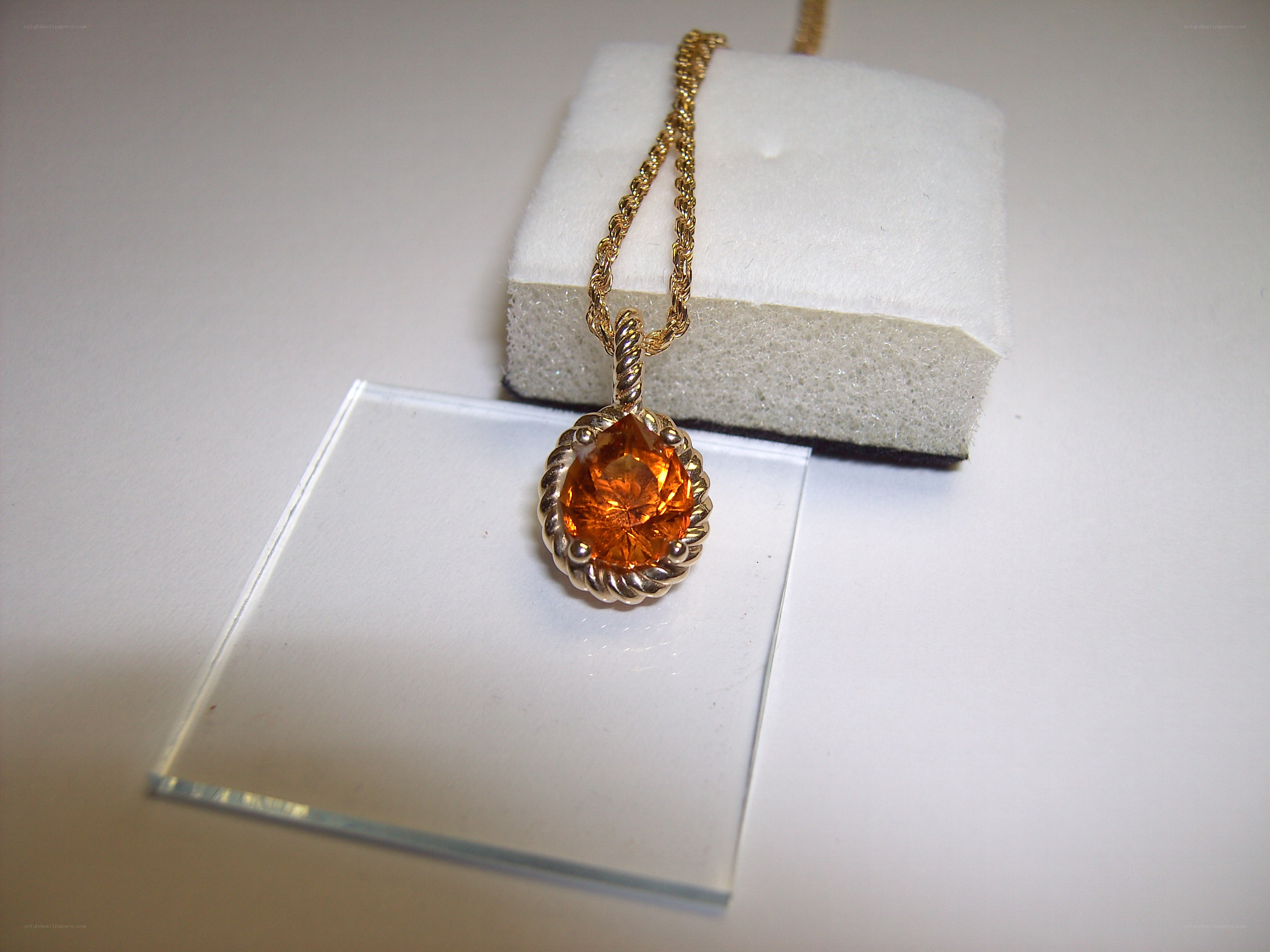 gold necklace with orange gemstone