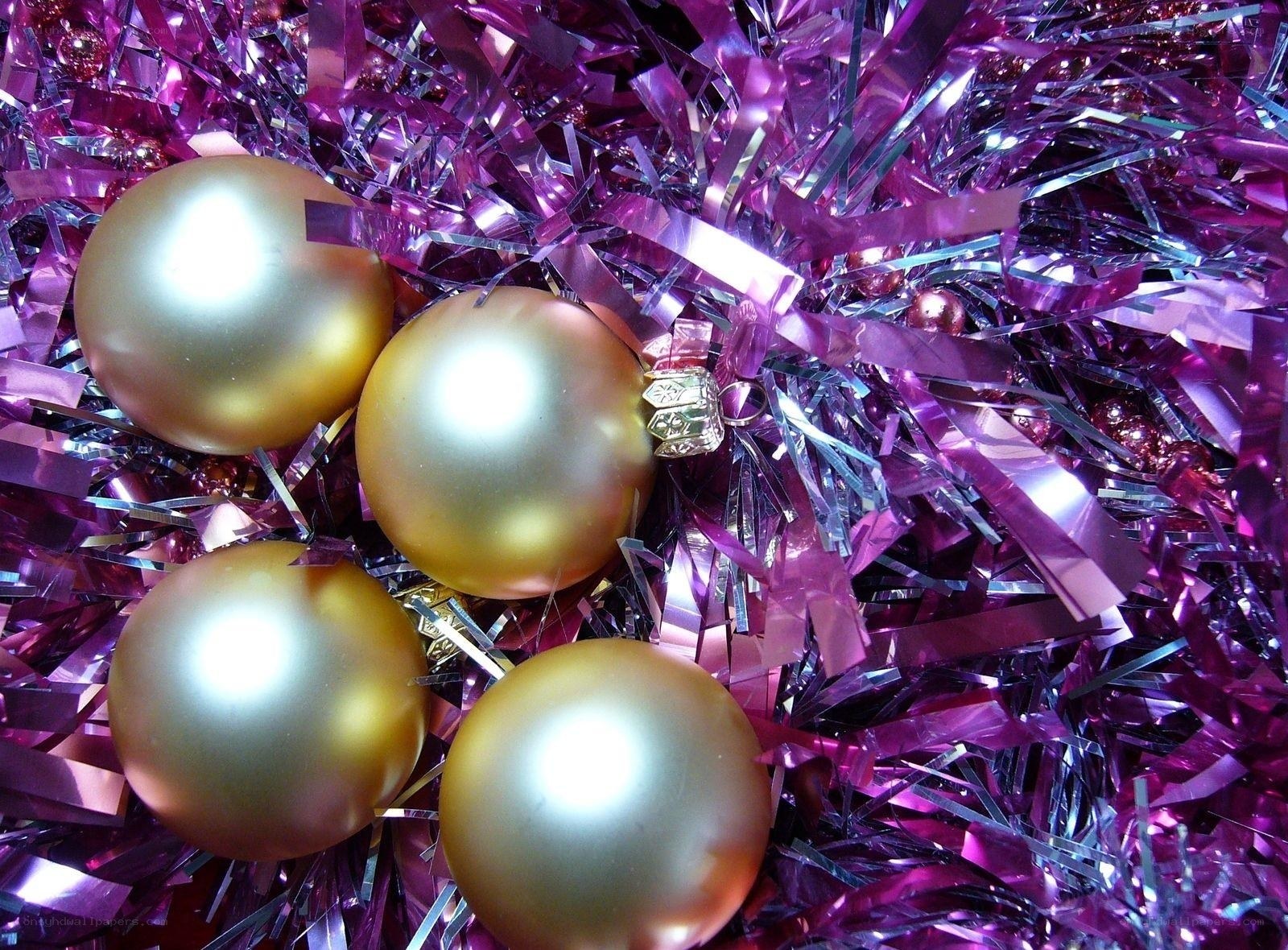 gold ornaments on purple tinsel