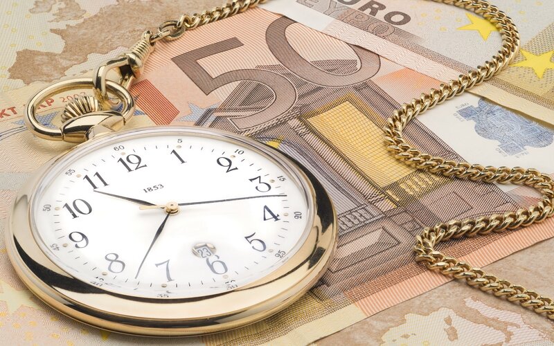 gold pocket watch on euro bills