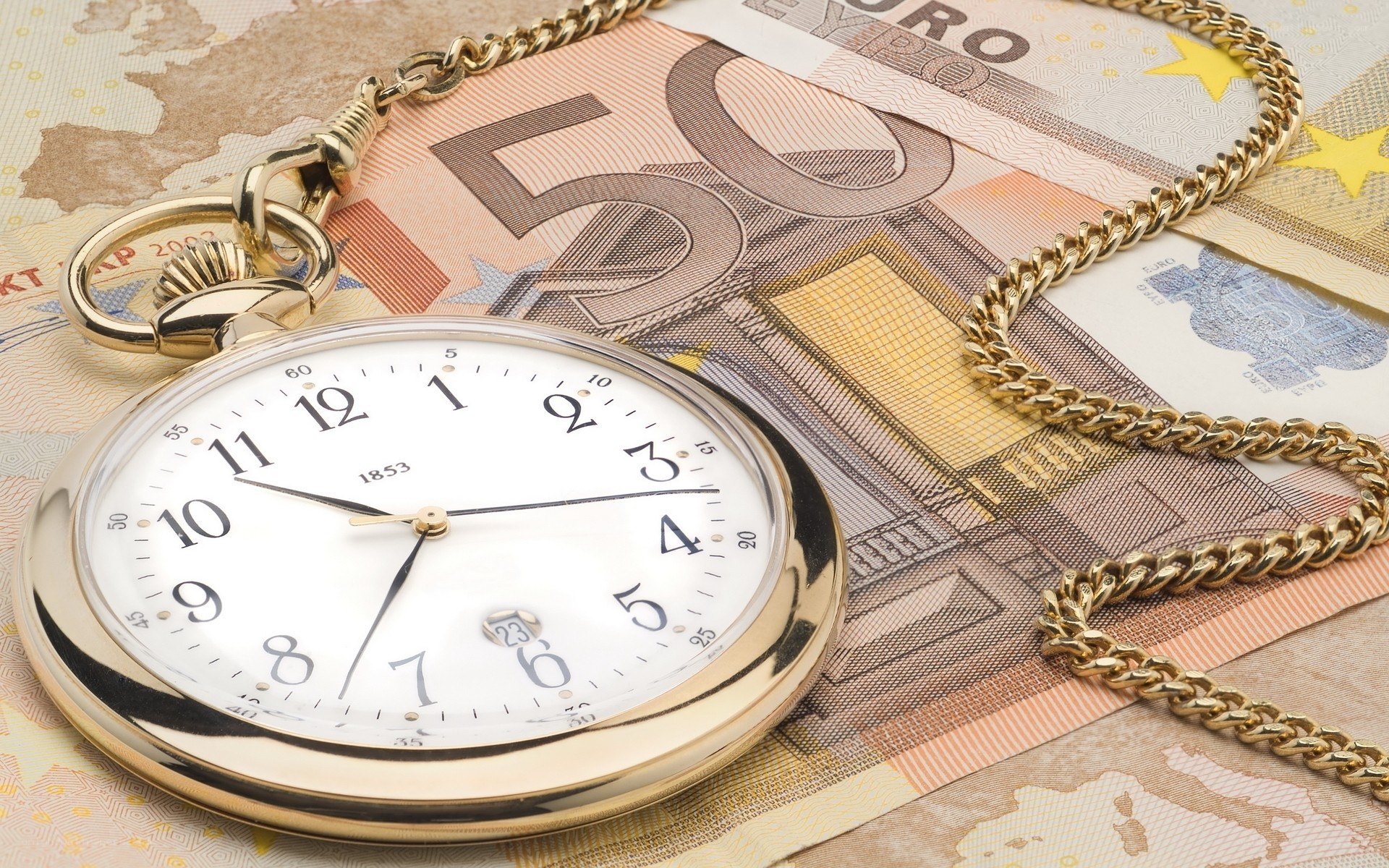 gold pocket watch on euro bills
