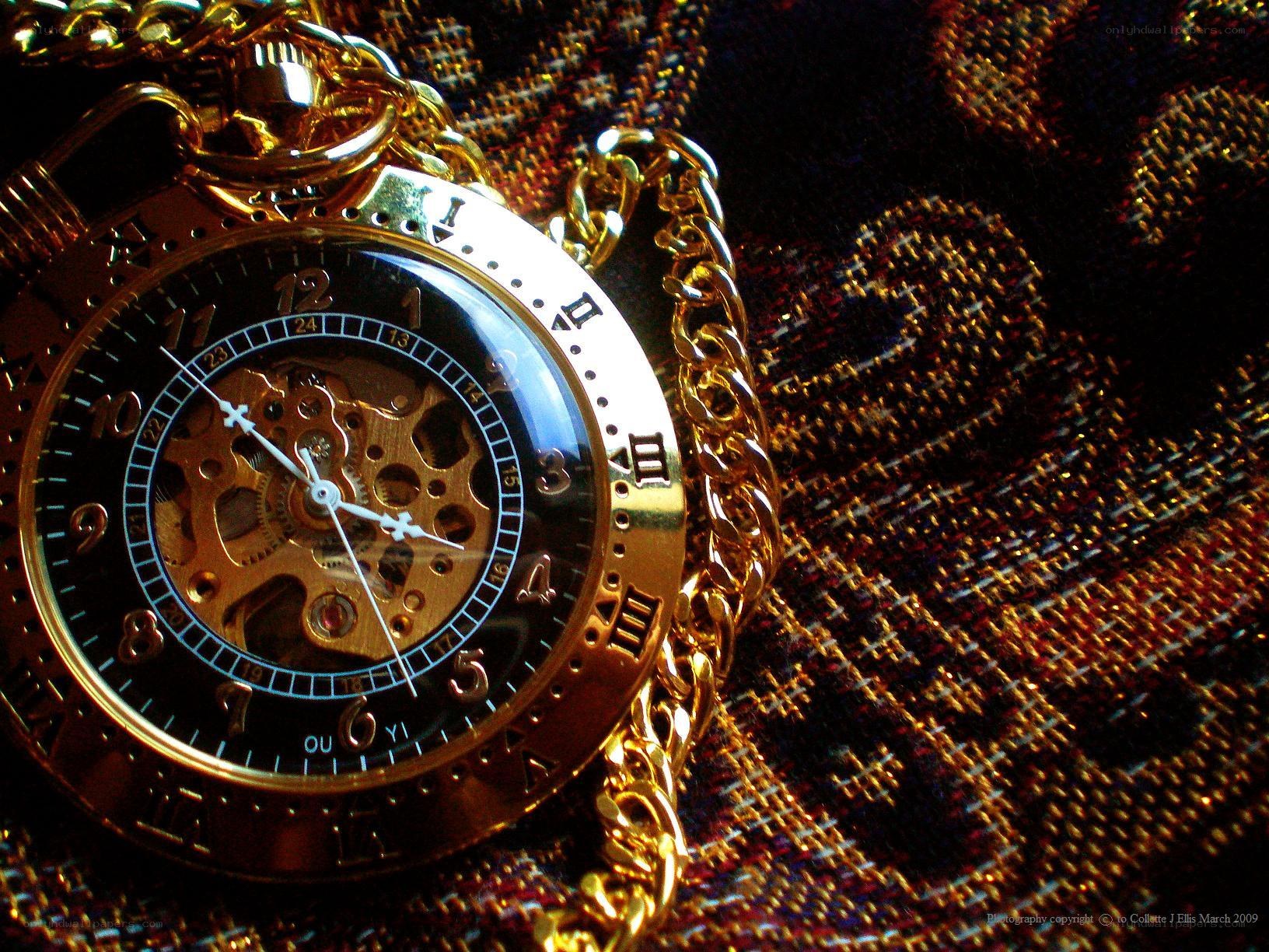 gold pocket watch on fabric