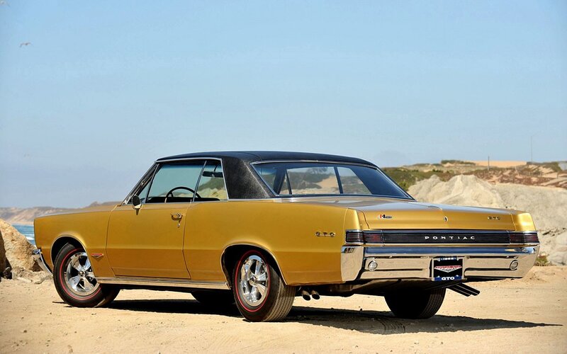 Gold Pontiac GTO on beach
