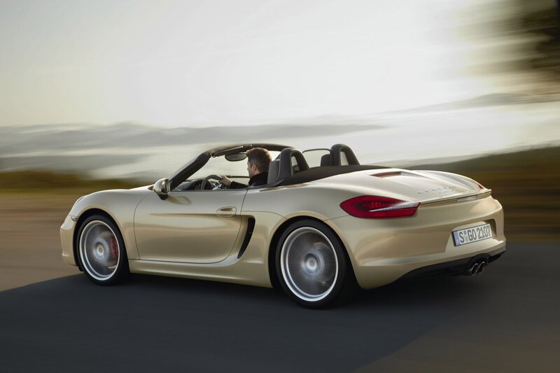 Gold Porsche Boxster in motion