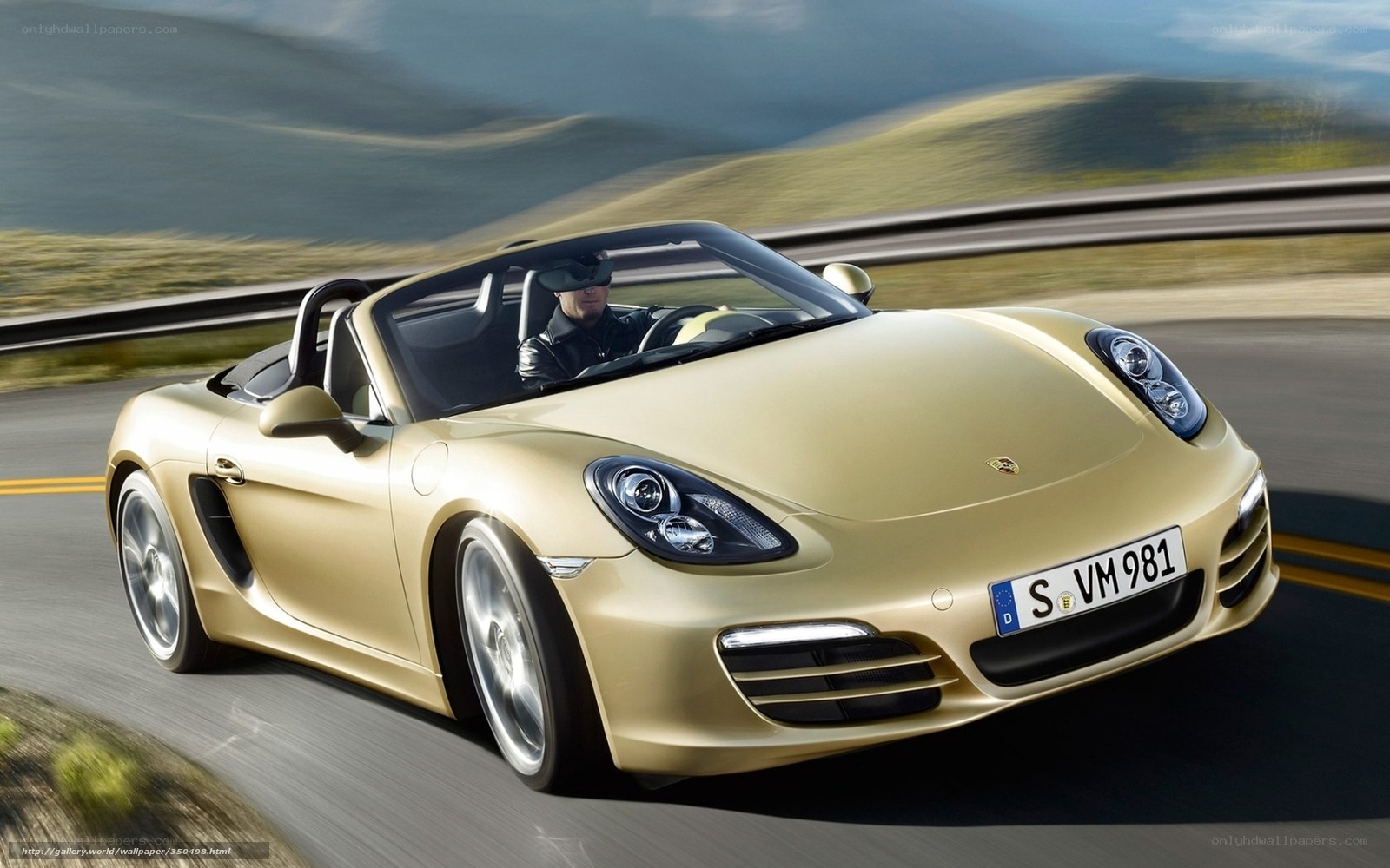 Gold Porsche Boxster in motion