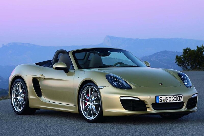 Gold Porsche Boxster on a mountain road