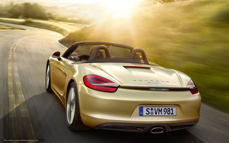 Gold Porsche convertible on road