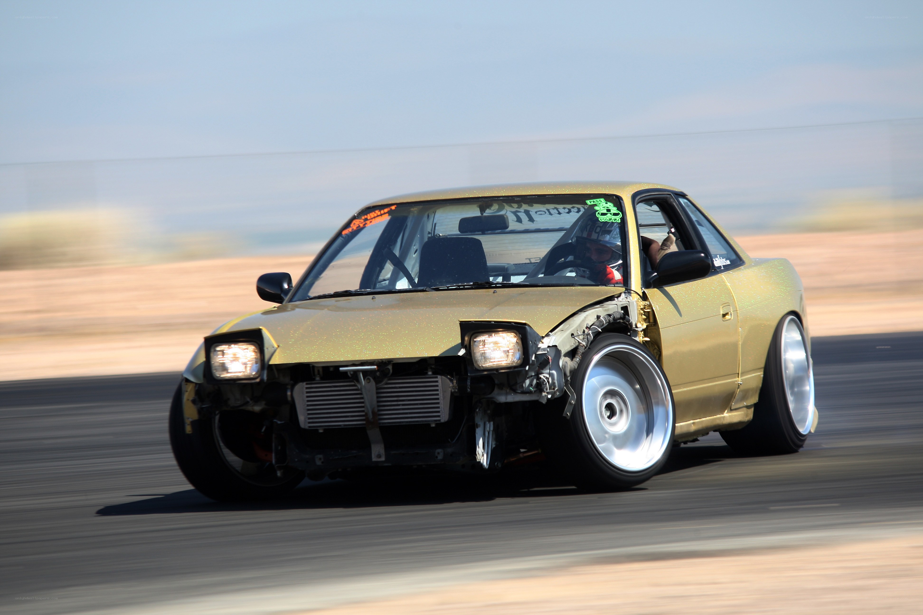 gold race car on track