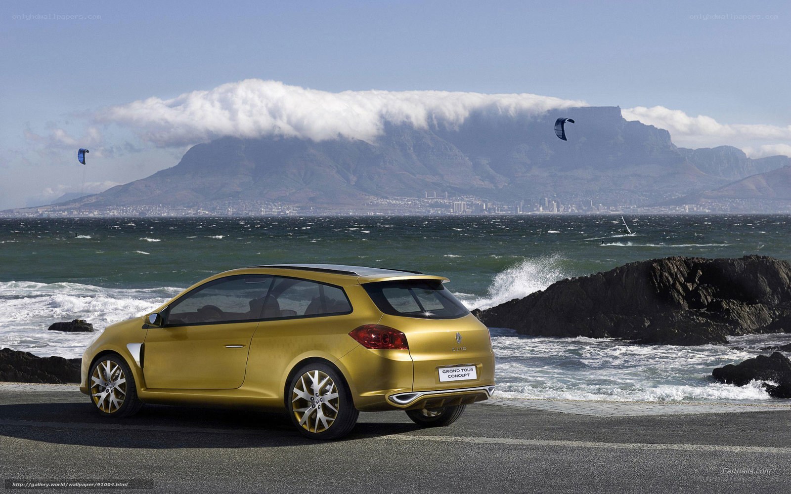 Gold Renault Clio on coastal road