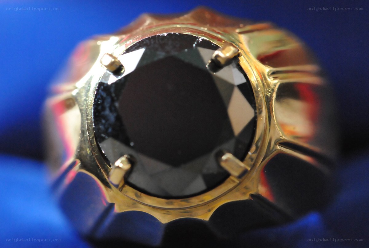 gold ring with black gemstone