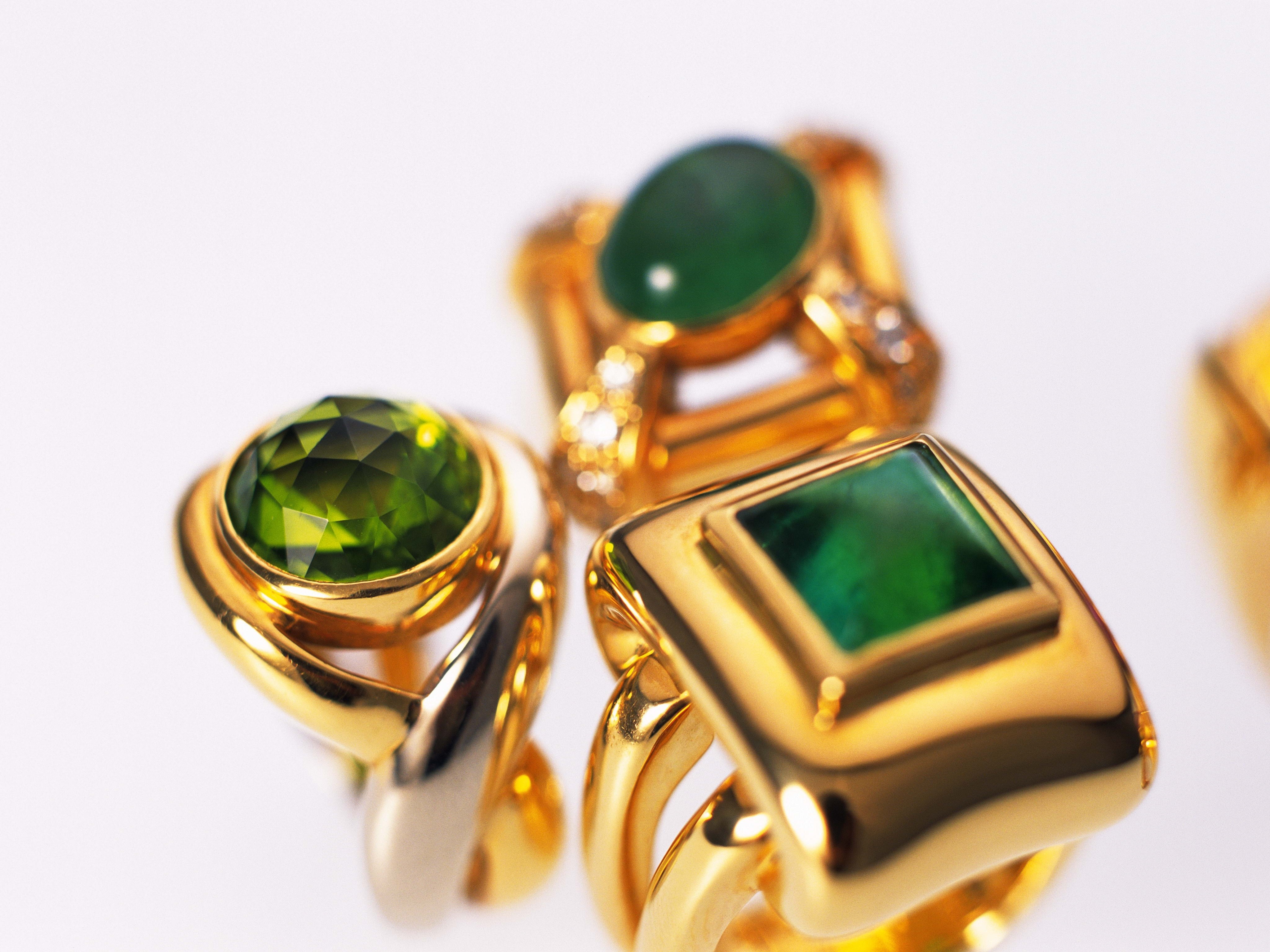 Gold rings with green gemstones