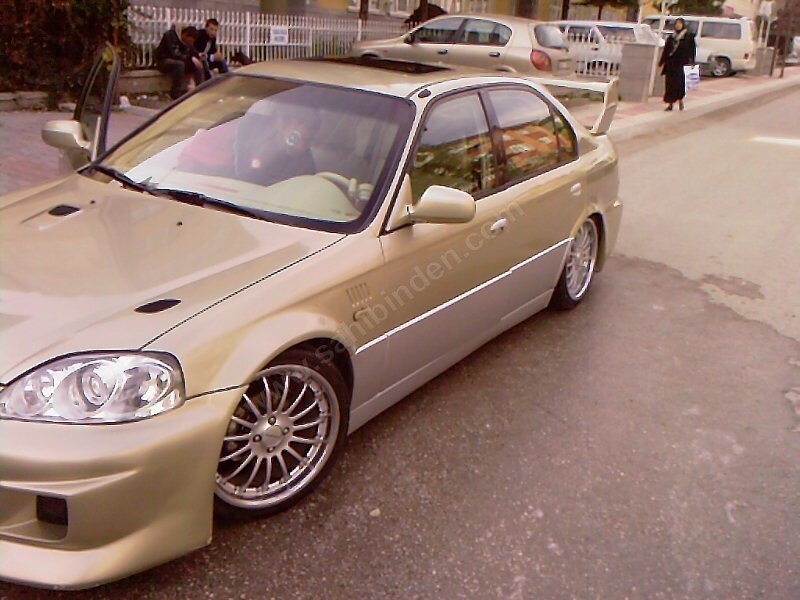 gold sedan with custom wheels