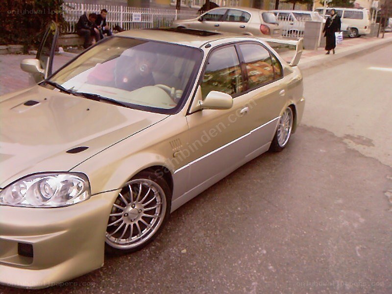 gold sedan with custom wheels