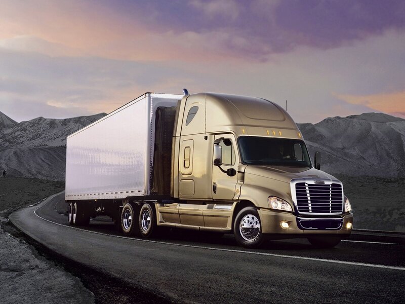 gold semi-truck on mountain road