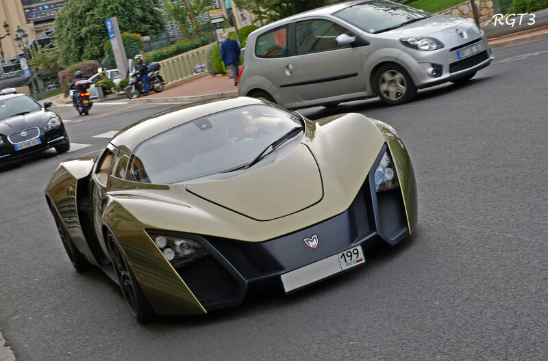 gold sports car on city street