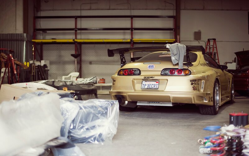 Gold Toyota Supra in a garage