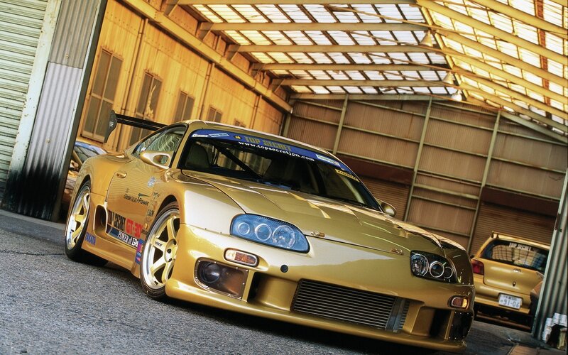 gold toyota supra in garage
