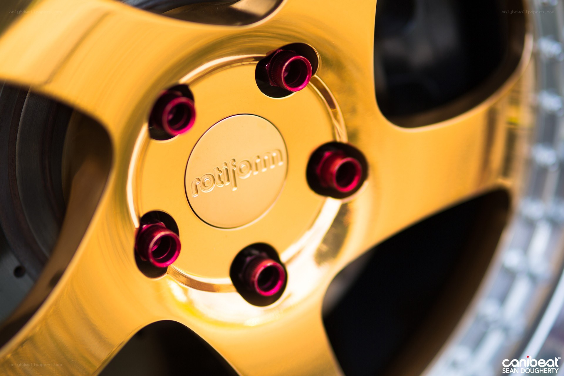 gold wheel with red lug nuts