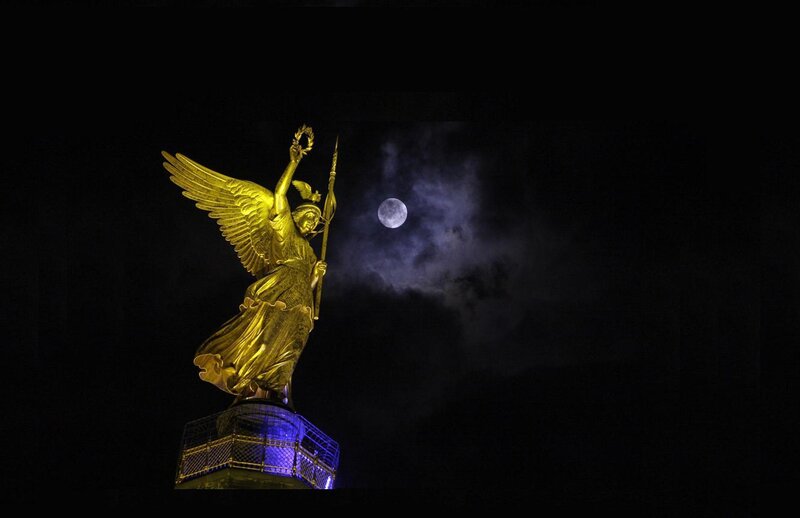 Golden angel statue at night