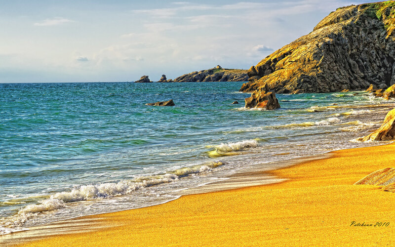 Golden beach with rocky cliffs