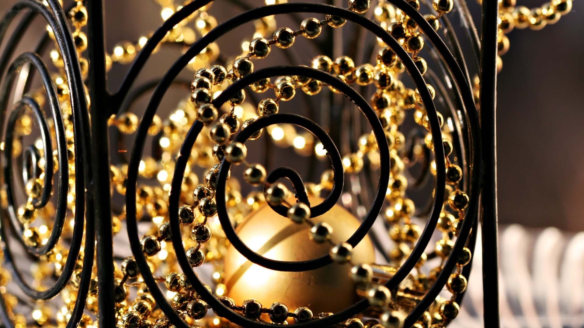 golden beads in a spiral frame