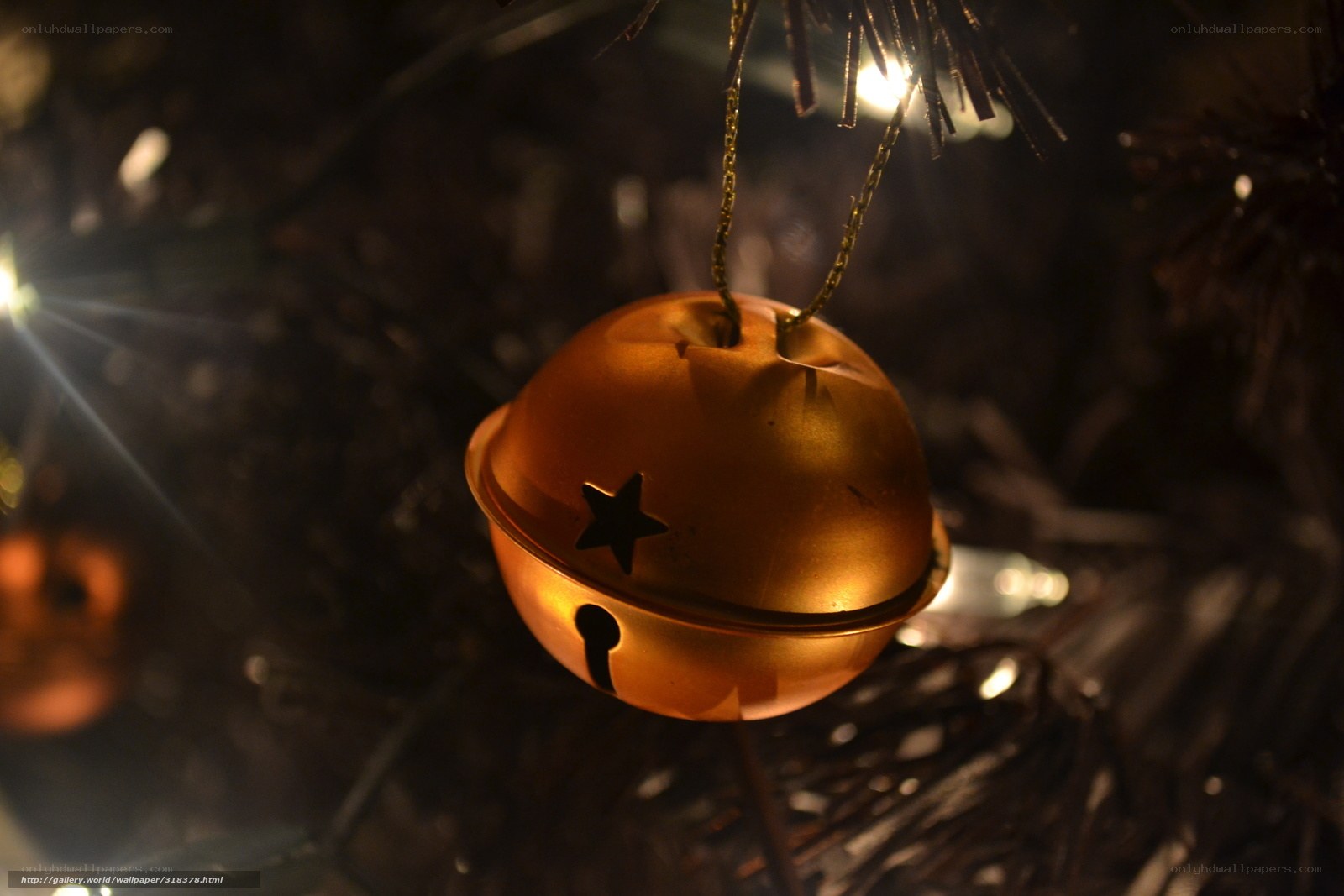 Golden bell ornament on tree