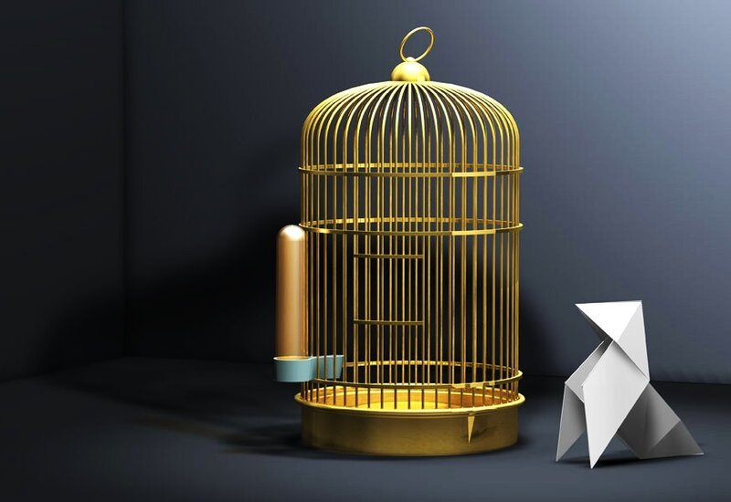 Golden birdcage with origami figure