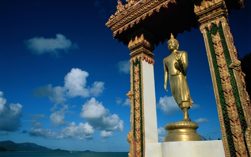 Golden Buddha statue by the sea