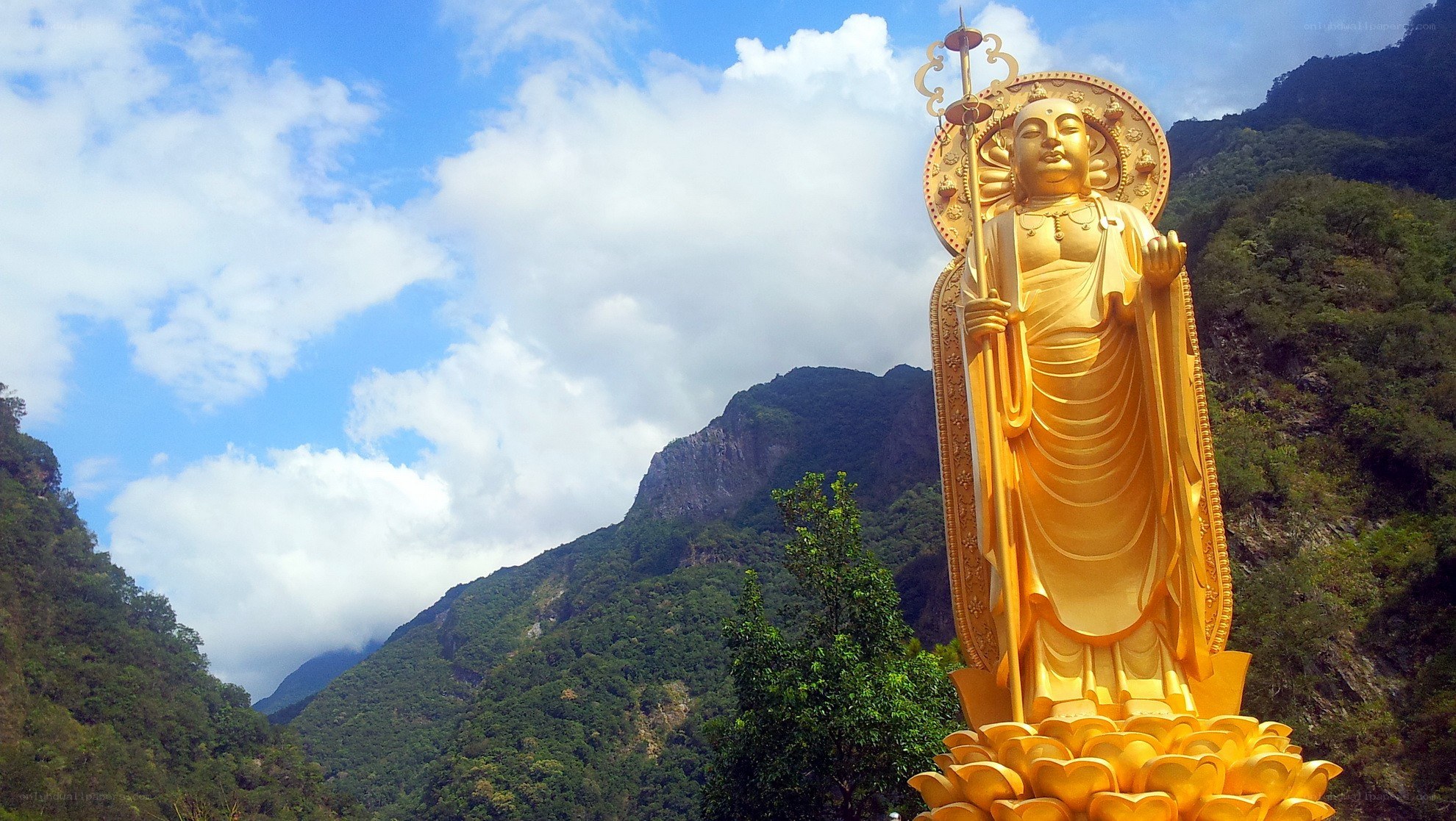 Golden Buddha statue in mountains