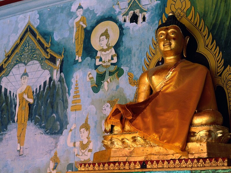 Golden Buddha statue with mural