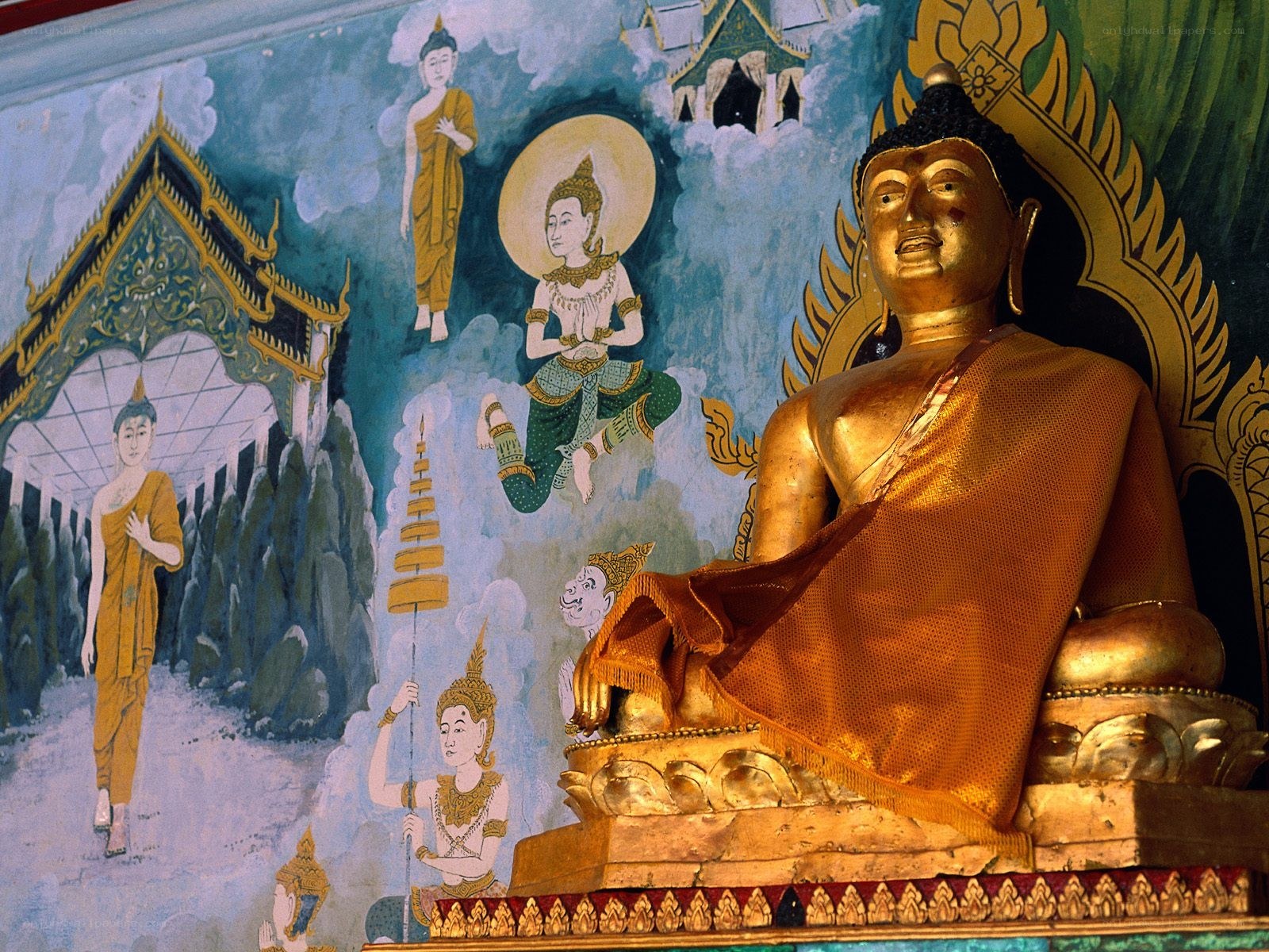 Golden Buddha statue with mural
