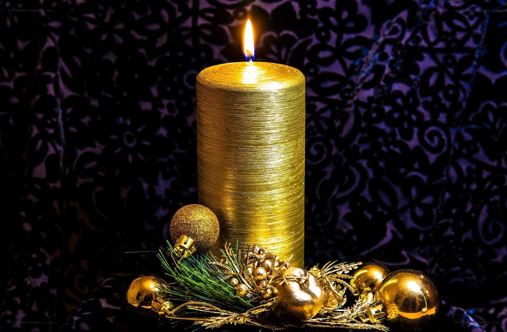 Golden candle with ornaments