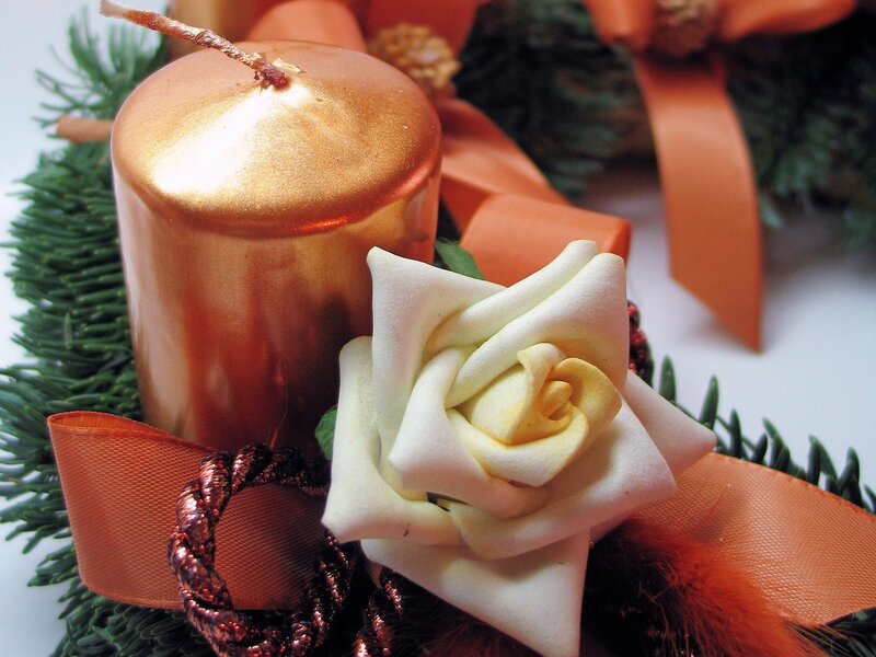golden candle with white rose