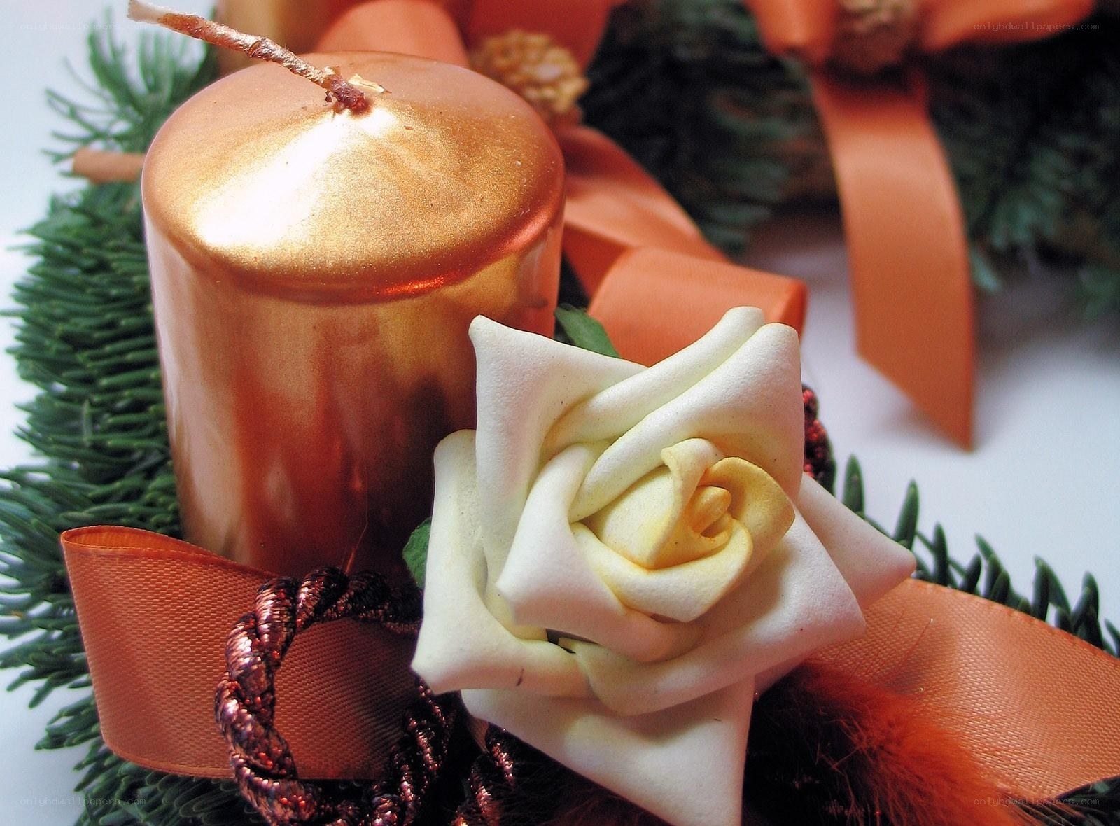 golden candle with white rose