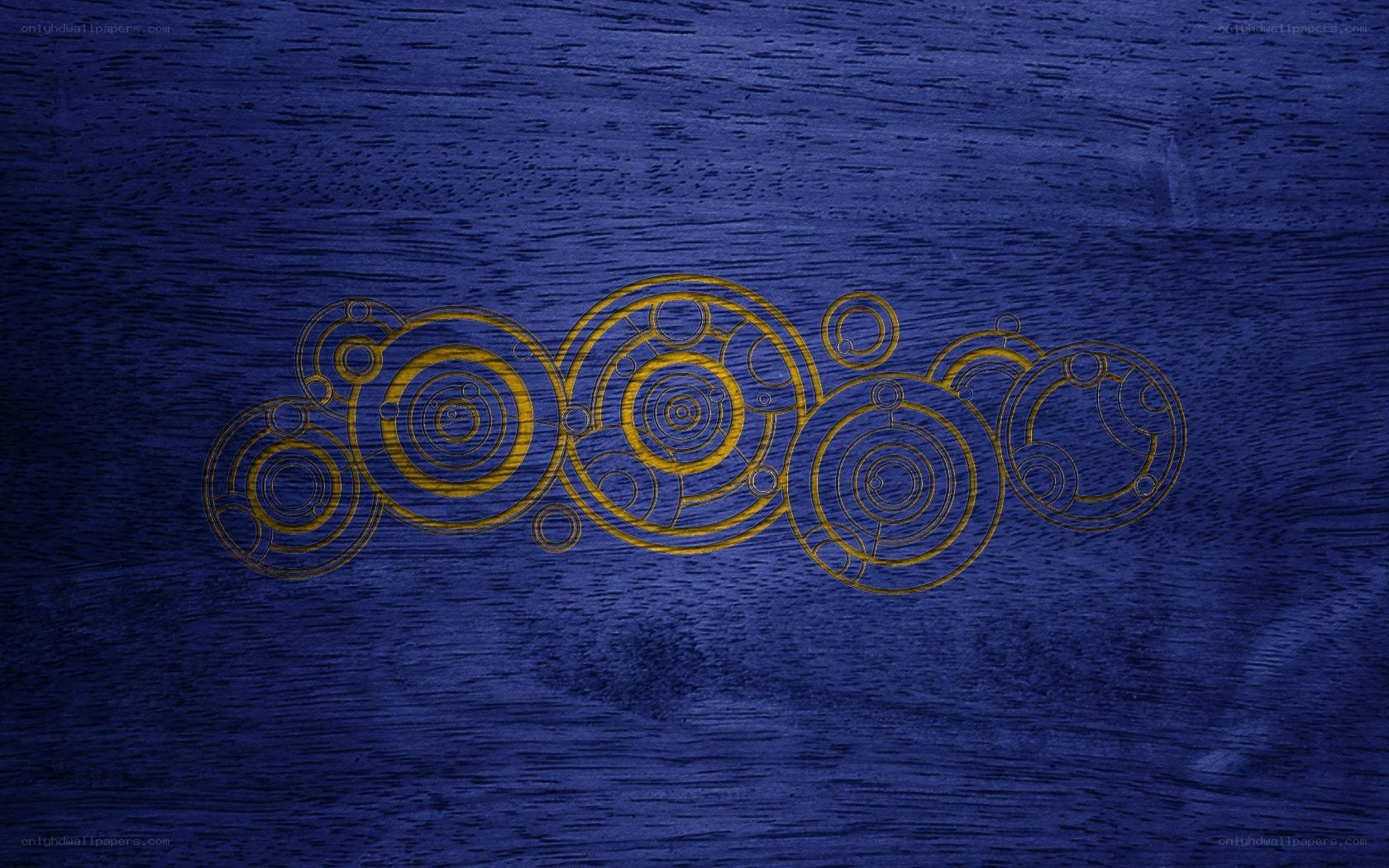 golden circular design on blue wood